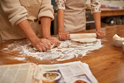 Midsection of man preparing food on table