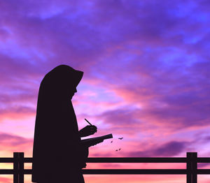 Low angle view of silhouette statue against sky during sunset