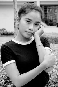 Portrait of girl sitting on field