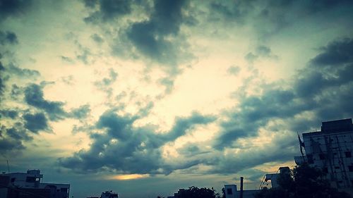 Low angle view of building against cloudy sky