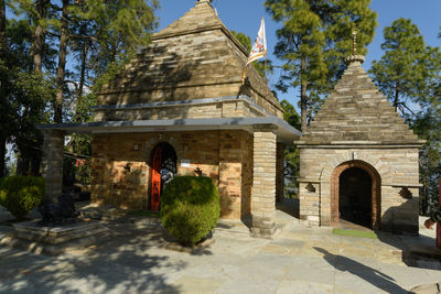 Rear view of woman standing outside temple