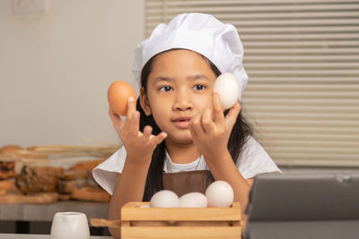 Portrait of smiling girl on table