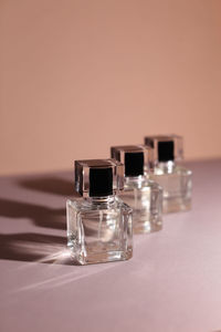 Close-up of perfume on colored background