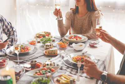 Midsection of people having food at table