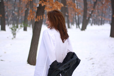 Woman standing on snow covered land