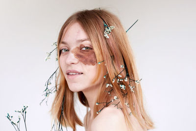 Portrait of woman against white background