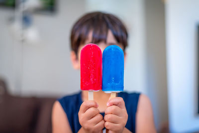 Close-up of boy holding flavored ices