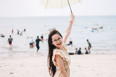 Portrait of young woman standing on beach