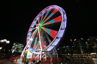 Low angle view of ferris wheel at night