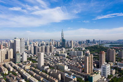 High angle view of modern buildings in city against sky