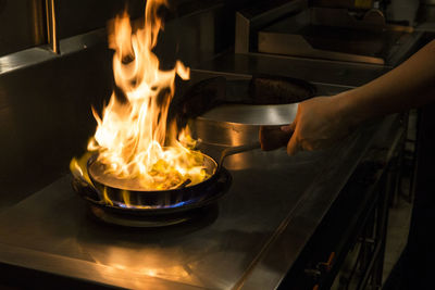 Midsection of man preparing food in kitchen