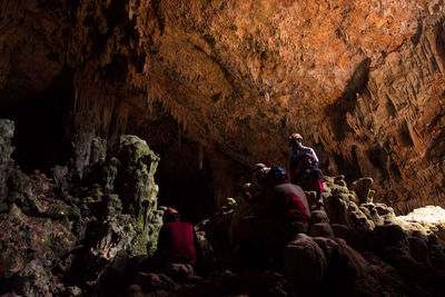 People sitting in cave
