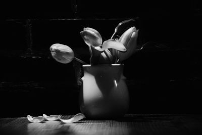 Close-up of vase on table against black background