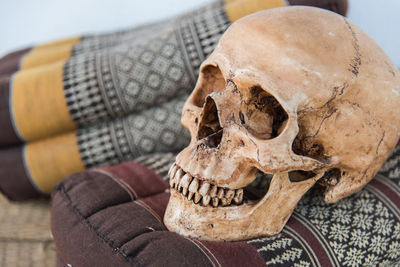 Close-up of human skull on cushion