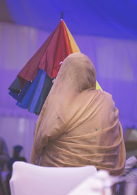 Close-up of a man with woman in background