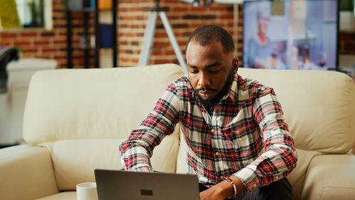 Young man using laptop at home