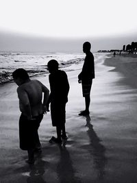 Full length of people walking on beach