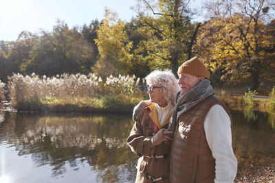 Senior couple next to lake in park