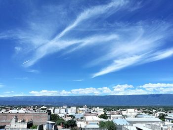 Panoramic view of cityscape against blue sky