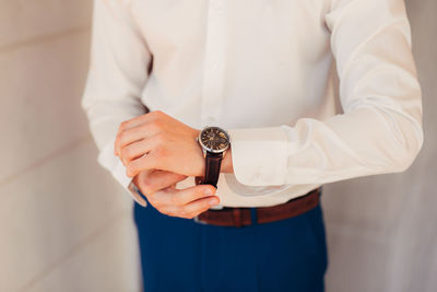 Midsection of man holding hands at home