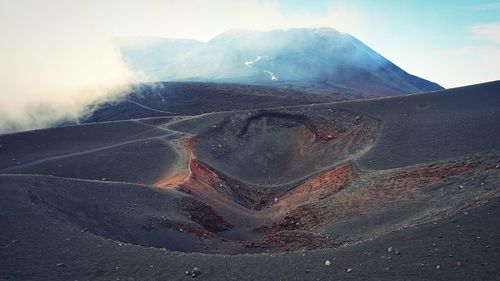 Aerial view of volcanic landscape against sky