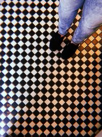 Low section of woman standing on tiled floor