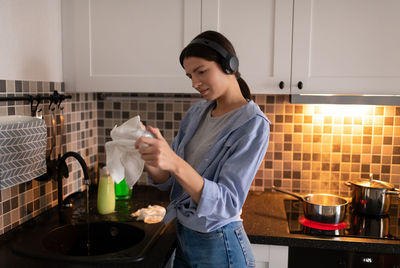 Young woman smiling while standing at home