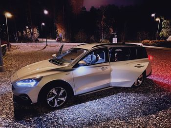 Car parked on street at night