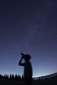 Silhouette of person against night sky