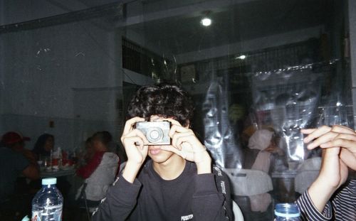 Portrait of a man drinking glass in restaurant