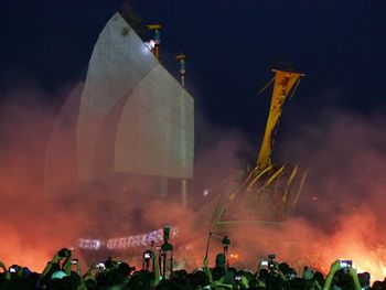 Crowd photographing ship during ceremony