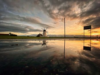 Scenic view of lake against sky during sunset