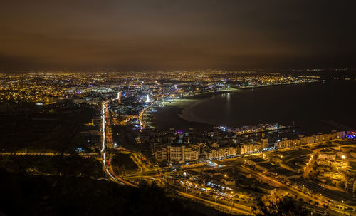 High angle view of city lit up at night