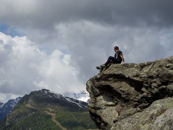 Rear view of man standing on cliff