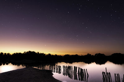 Scenic view of lake against sky at night