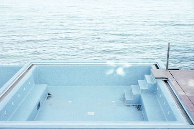 High angle view of empty swimming pool by sea