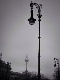 Low angle view of communications tower against sky