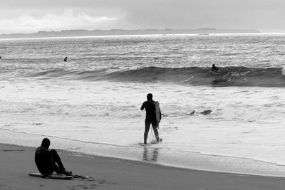 Men surfing in sea