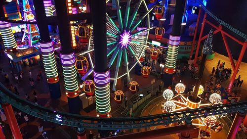 Low angle view of illuminated ferris wheel at night