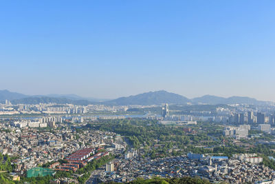 High angle view of cityscape against clear blue sky