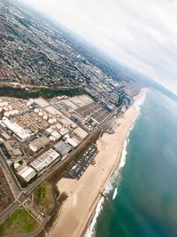 High angle view of cityscape by sea against sky