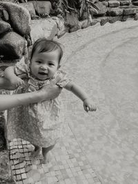 Smiling baby girl near swimming pool