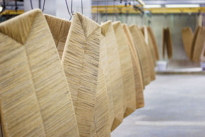 Close-up of covered wood hanging in factory