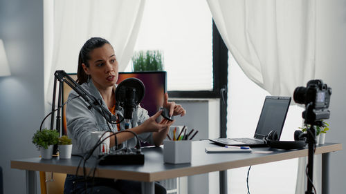 Young woman using laptop at home