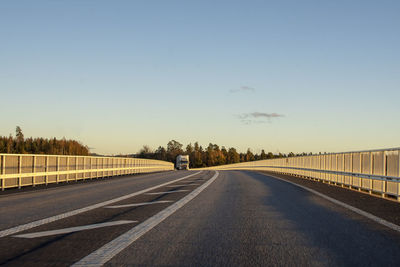 Road by trees against sky