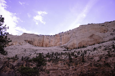 Low angle view of rocky mountains against sky