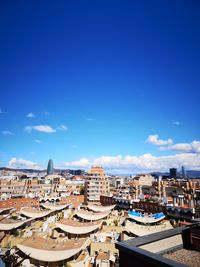 High angle view of buildings against blue sky