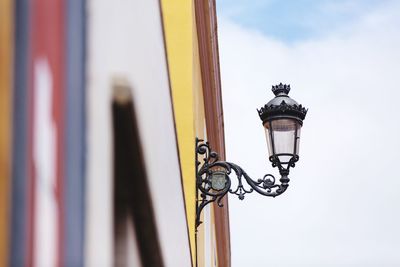 Low angle view of gas light on wall