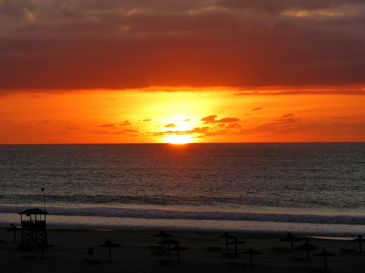 sunset, sea, horizon over water, beach, scenics, water, orange color, tranquil scene, sun, sky, beauty in nature, tranquility, idyllic, shore, nature, cloud - sky, sand, remote, silhouette, cloud