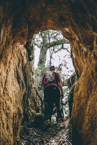 Rear view of man standing on rock formation